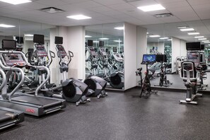 A gym with treadmills, elliptical machines, and weight machines. - Arlo Chicago (Chicago)