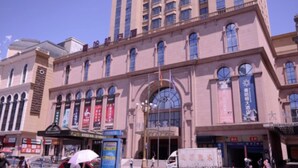 A large, historic building with arched windows and a central entrance.