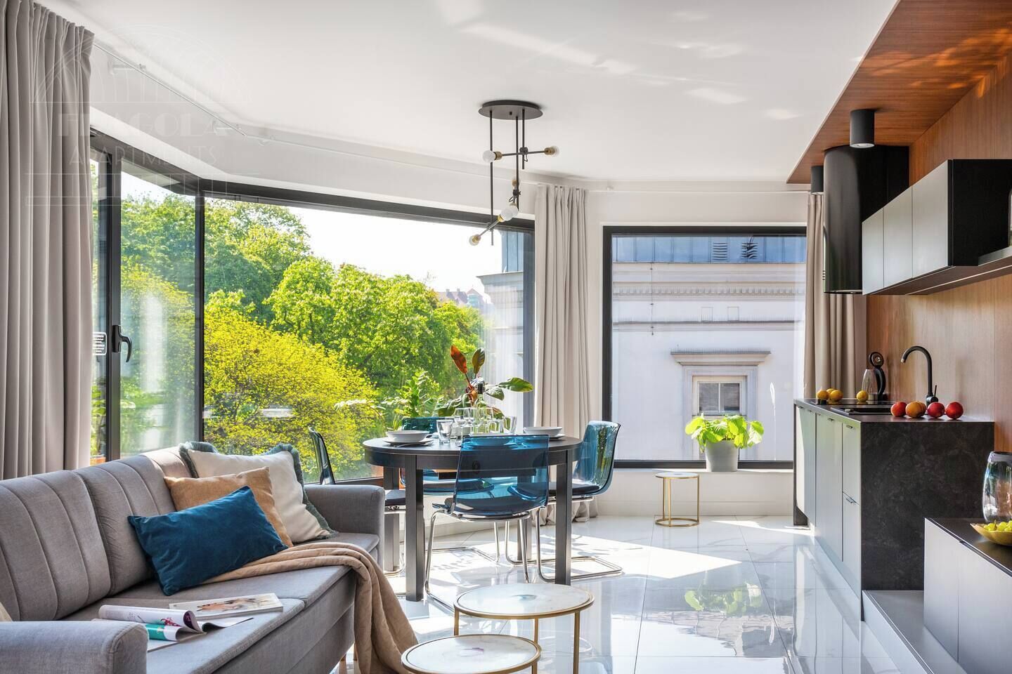 A modern living room with a sofa, coffee table, and dining area.