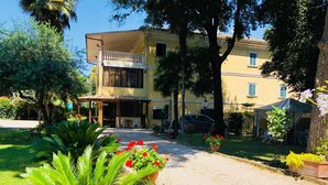 A two-story building with a covered patio and a car parked in front.