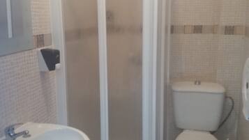 Un bany amb plat de dutxa, un lavabo i un vàter.