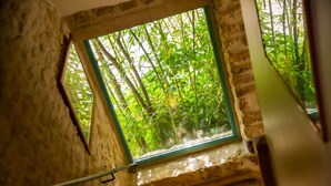 A room with a window overlooking a bamboo forest. - Maison d'Hôtes La Ferme de L'Oudon & Spa (Saint-Pierre-en-Auge)