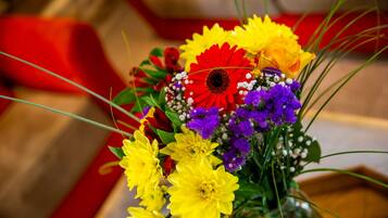 A bouquet of flowers with red, yellow, and purple blooms.