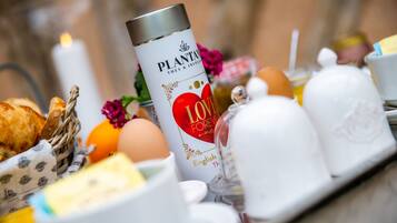 A breakfast setting with a bottle labeled "PLANT & INFUSION" and a heart-shaped decoration.