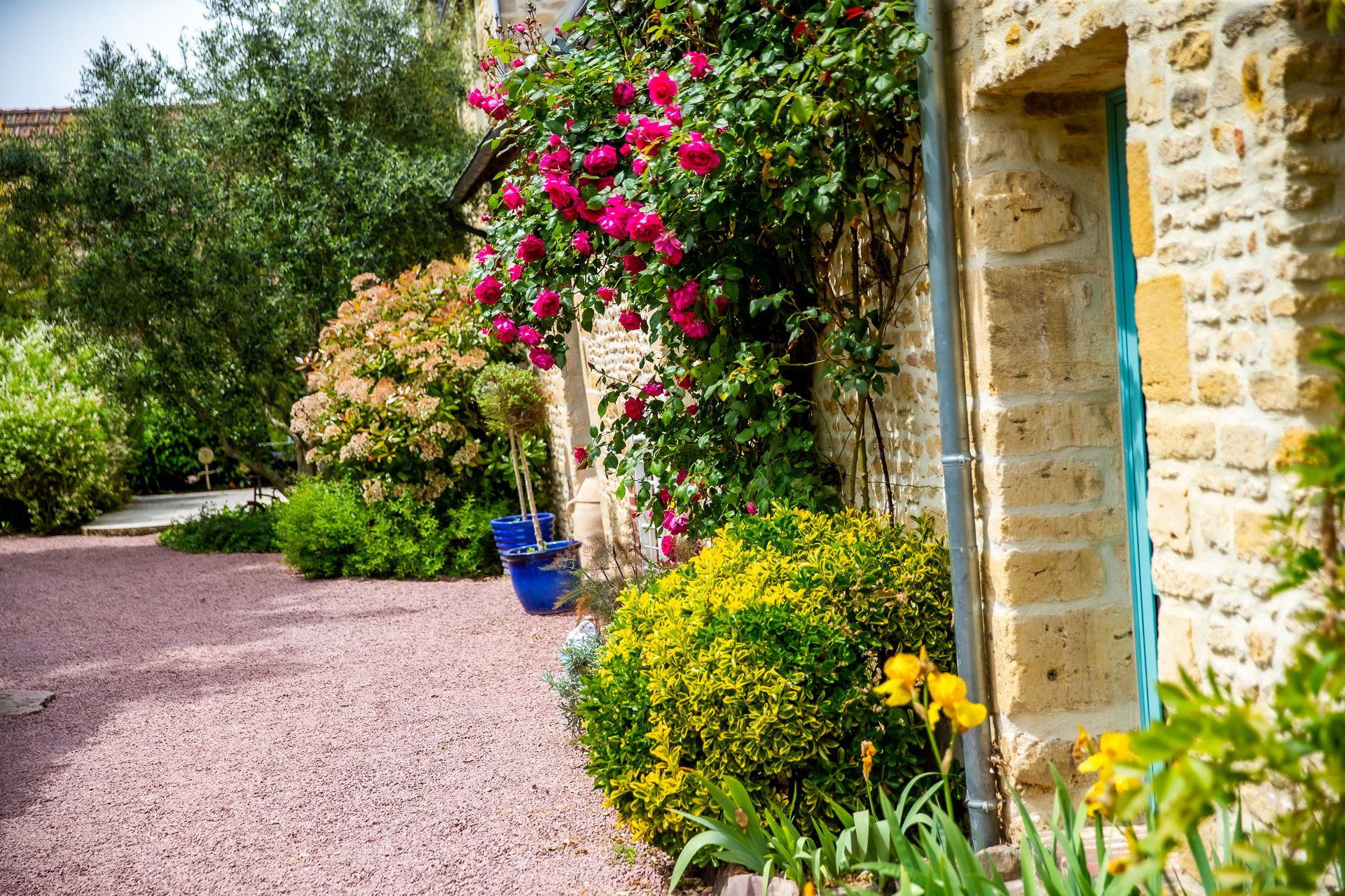 A stone building with a garden path leading to a door.