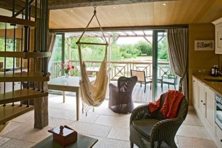 House on the Water - LE LAVOIR | Living room | Flat-screen TV, fireplace, heated floors. Maison d'Hôtes La Ferme de L'Oudon & Spa