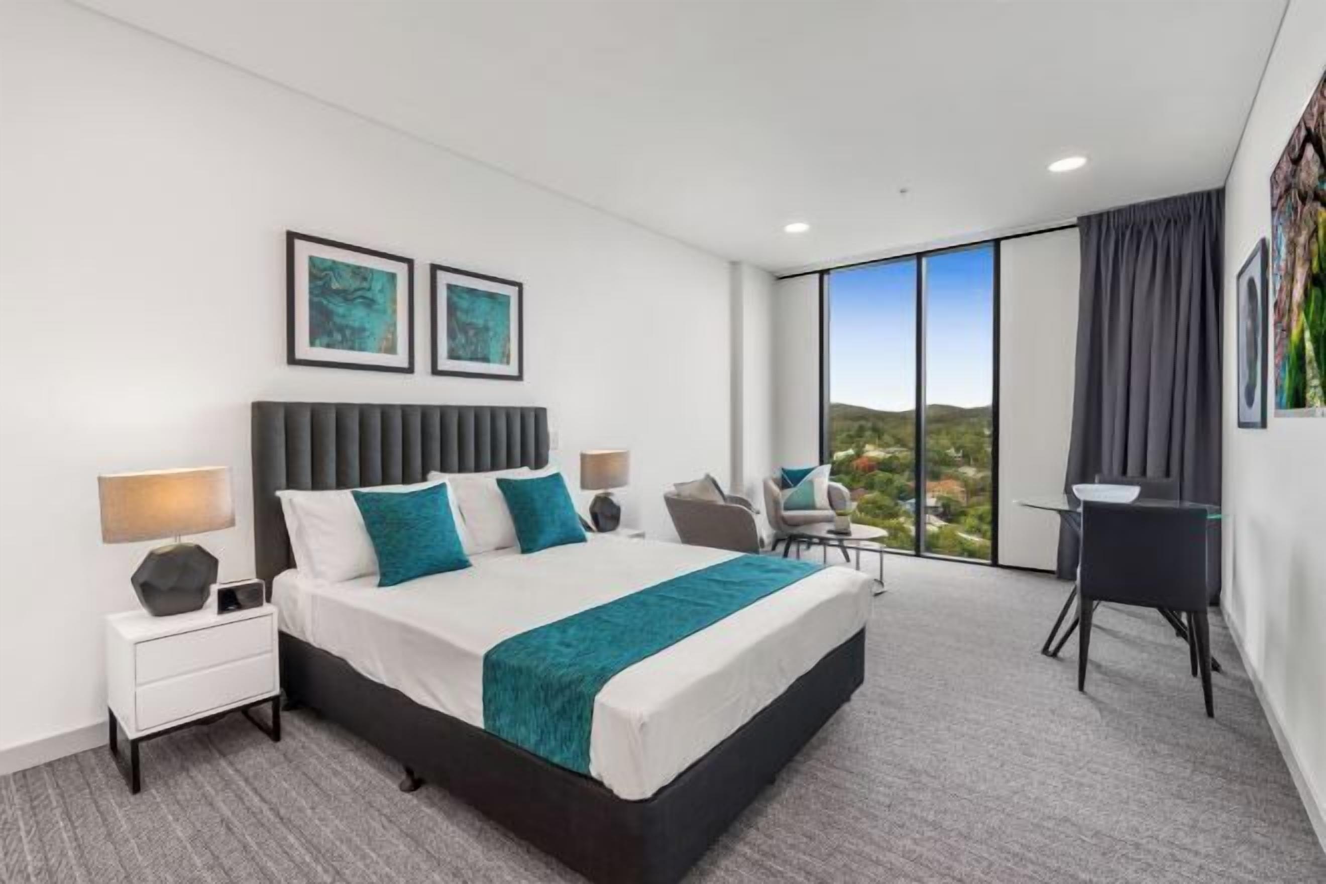Premium bedding, laptop workspace, blackout curtains, soundproofing