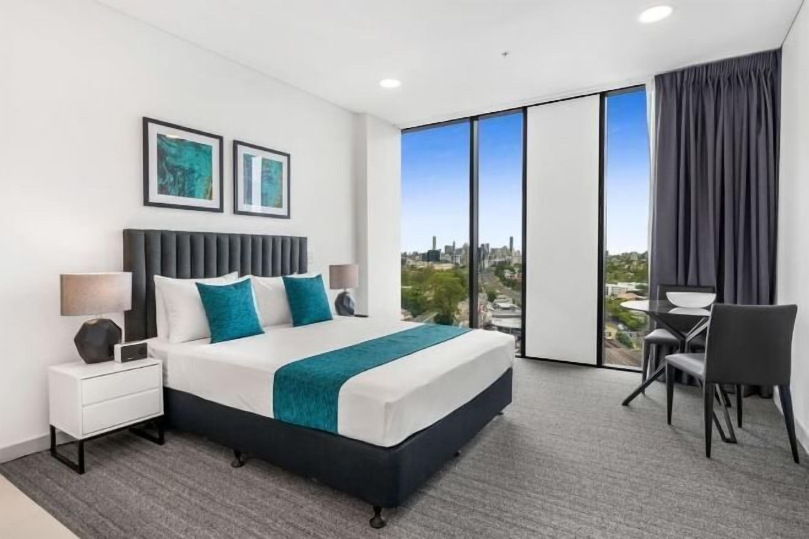 Premium bedding, laptop workspace, blackout curtains, soundproofing