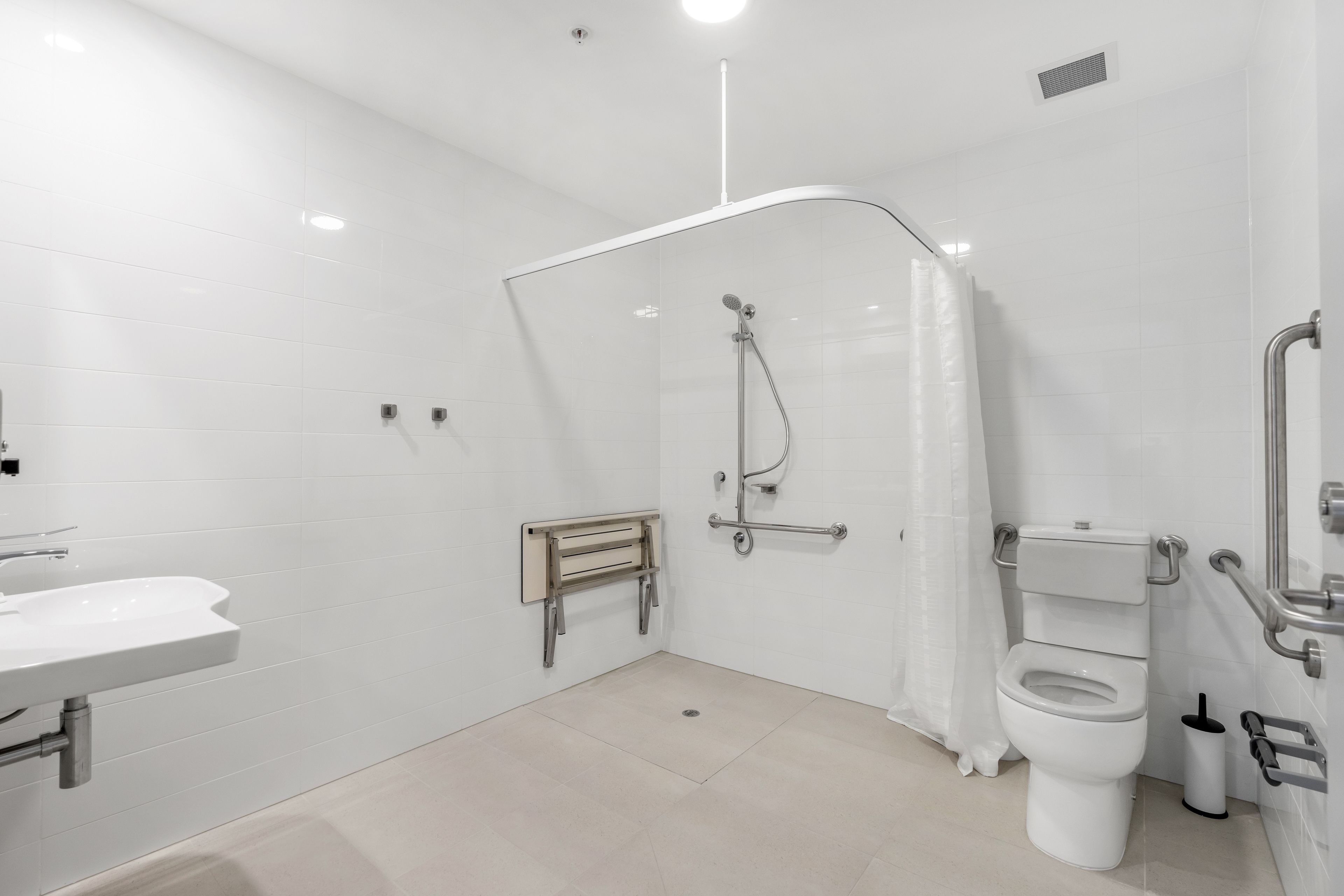 Un baño moderno con ducha, inodoro y lavamanos.
