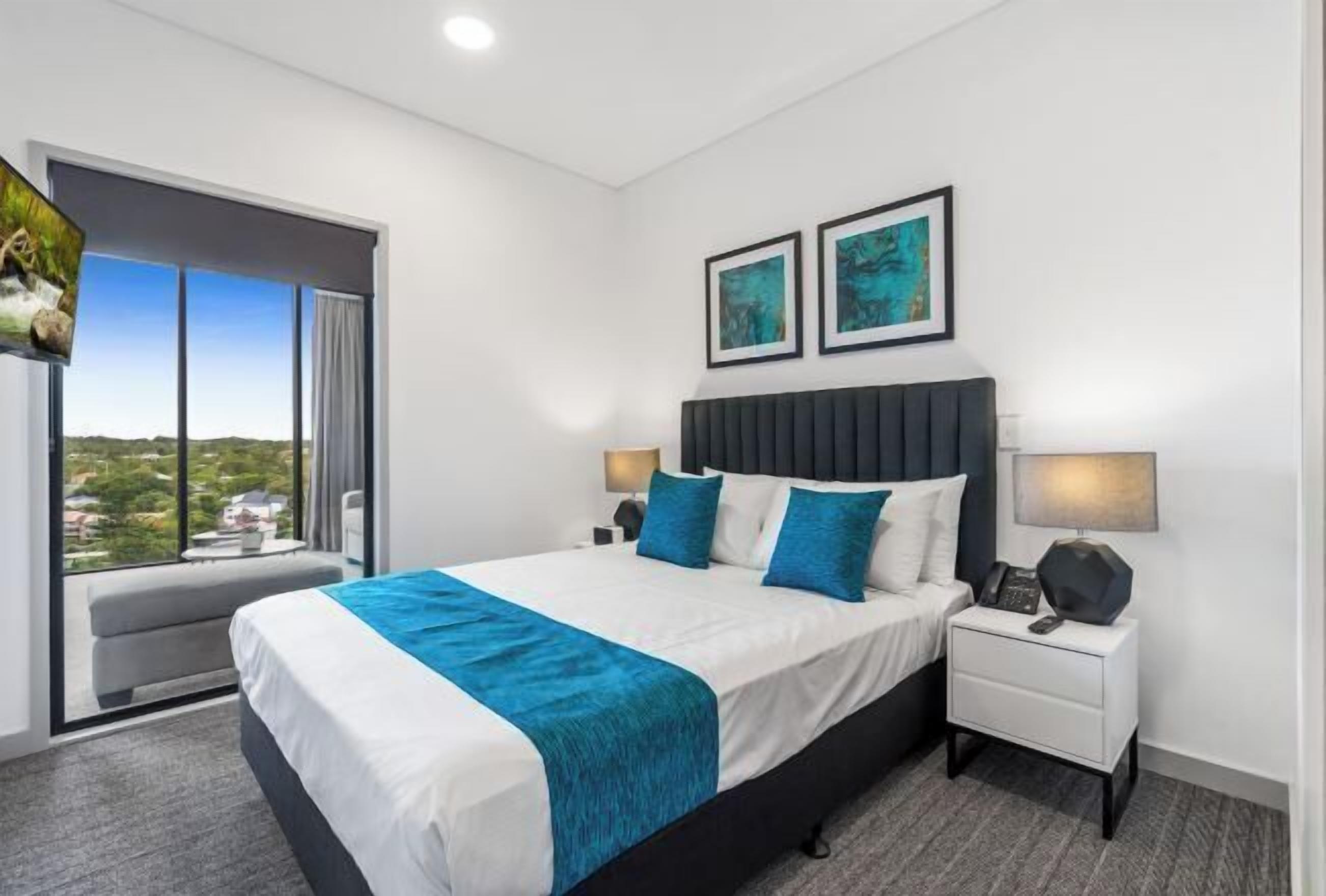Premium bedding, laptop workspace, blackout curtains, soundproofing