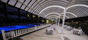 An outdoor pool area with a covered seating area and a pool. - Jasmin Court Apart Otel (Silifke)