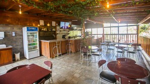 A restaurant with a bar area, seating, and a drinks machine. - Serene Valley Apartments & Spa (Nairobi)