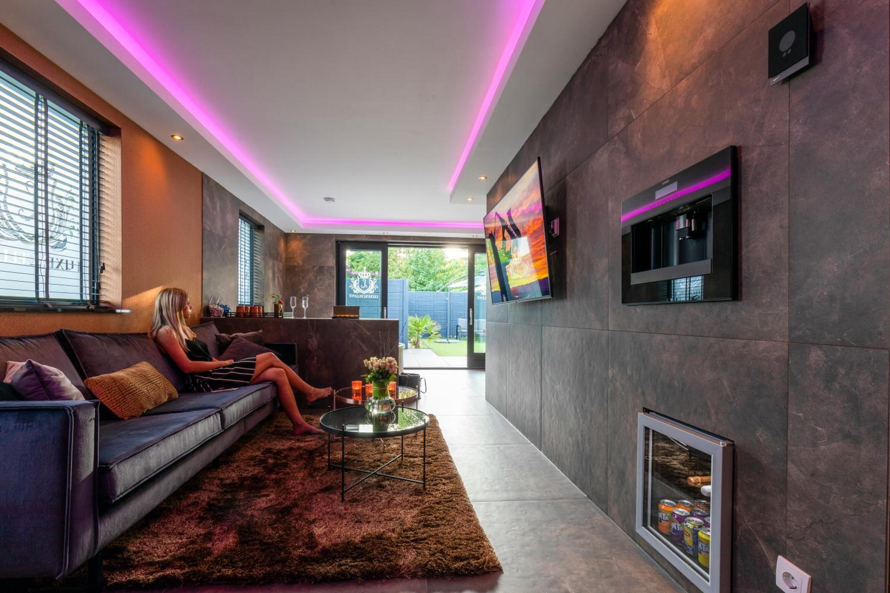 A modern living room with a sofa, a coffee table, and a fireplace.