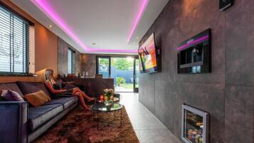 A modern living room with a sofa, a coffee table, and a fireplace.