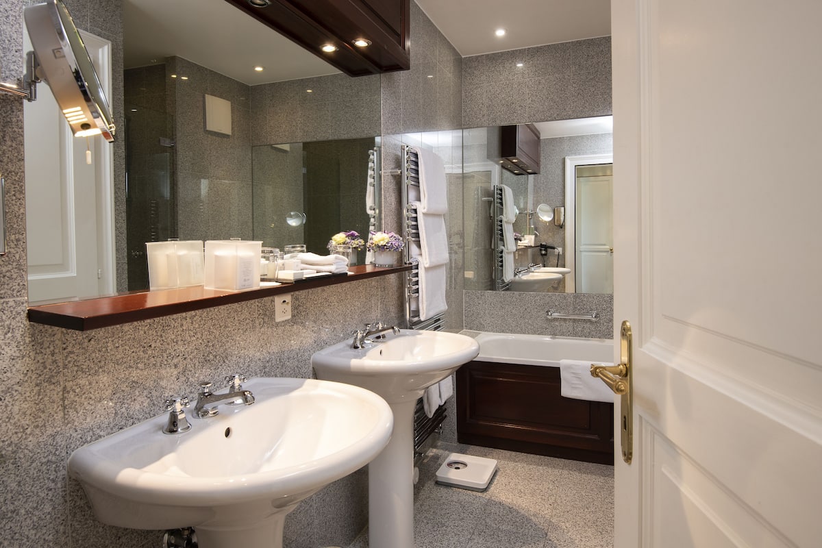 junior suite, lake view | bathroom | separate bathtub and shower, free toiletries, hair dryer, bathrobes