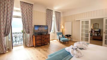 A hotel room with a bed, a TV, a desk, and a chair.