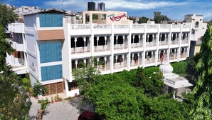 A multi-story hotel with a traditional architectural style, featuring balconies and a central courtyard. - Hotel Vinayakam (Udaipur)
