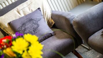 A chair with a cushion featuring a decorative design.