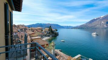 Enjoy breathtaking views of the serene lake and quaint town from this lakeside balcony.