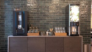 A coffee station with a coffee machine and a water dispenser, and a refrigerator with a water dispenser. - Hotel City (Holstebro)