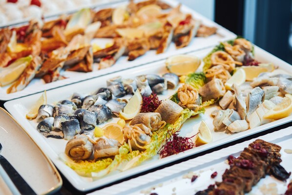 A variety of seafood dishes on a buffet table.