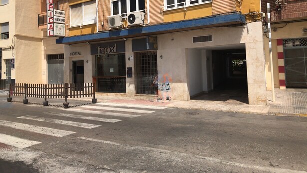 A building with a sign reading "Tropical" and "Hostal". - Hostal Tropical (Oliva)