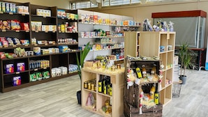 A store with shelves stocked with various food products, including snacks, beverages, and condiments. - Camping Du Pont D'Avignon (Avignon)