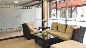 A modern living room with a sofa, armchairs, and a coffee table.