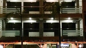 A multi-story building with a prominent sign reading "PASEO GRANDE INN".