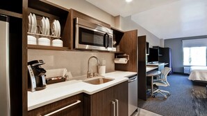 A modern kitchen with a built-in microwave, a coffee machine, and a sink. - Home2 Suites by Hilton Los Angeles Montebello (Montebello)