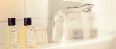 Two bottles of Taylor of London Natural Bath & Shower Gel and Shampoo & Conditioner on a bathroom counter.
