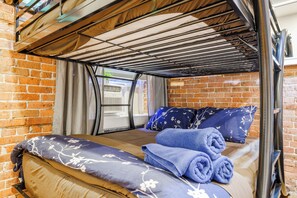 Cozy sleeping quarters with a bed, towels, and essentials.