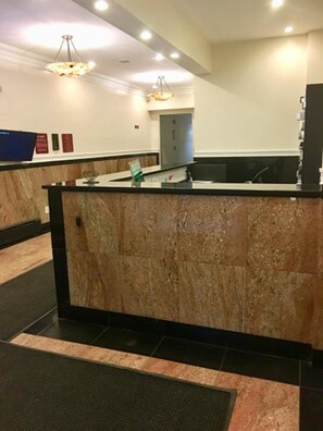 Welcome to the reception area, where guests can check in and enjoy the convenience of a television and comfortable seating.
