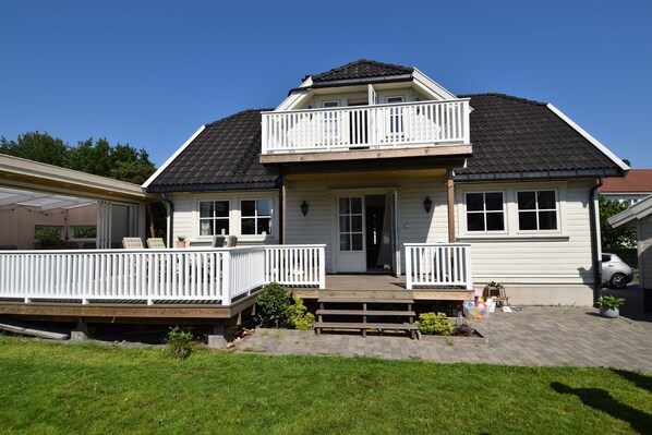 A two-story house with a balcony, a front porch, and a garage.