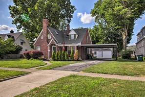 A two-story house with a garage, a covered porch, and a well-maintained lawn. - Indianapolis Vacation Rental - Walk to the IMS! (Indianapolis)