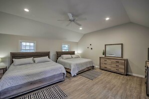 A bedroom with two beds, a ceiling fan, a dresser, and a mirror. - Indianapolis Vacation Rental - Walk to the IMS! (Indianapolis)