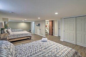 Ein Schlafzimmer mit zwei Betten, einem Kamin aus Ziegelsteinen und einer weißen Tür.