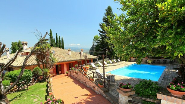 A pool area with a stone deck, lounge chairs, and potted plants. - Private Villa with A/C, hot tub, private pool, WIFI, TV, patio, pets allowed, panoramic view (Monte Compatri)