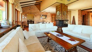 A spacious living room with a fireplace, white sofas, and a coffee table. - Private Villa with A/C, hot tub, private pool, WIFI, TV, patio, pets allowed, panoramic view (Monte Compatri)