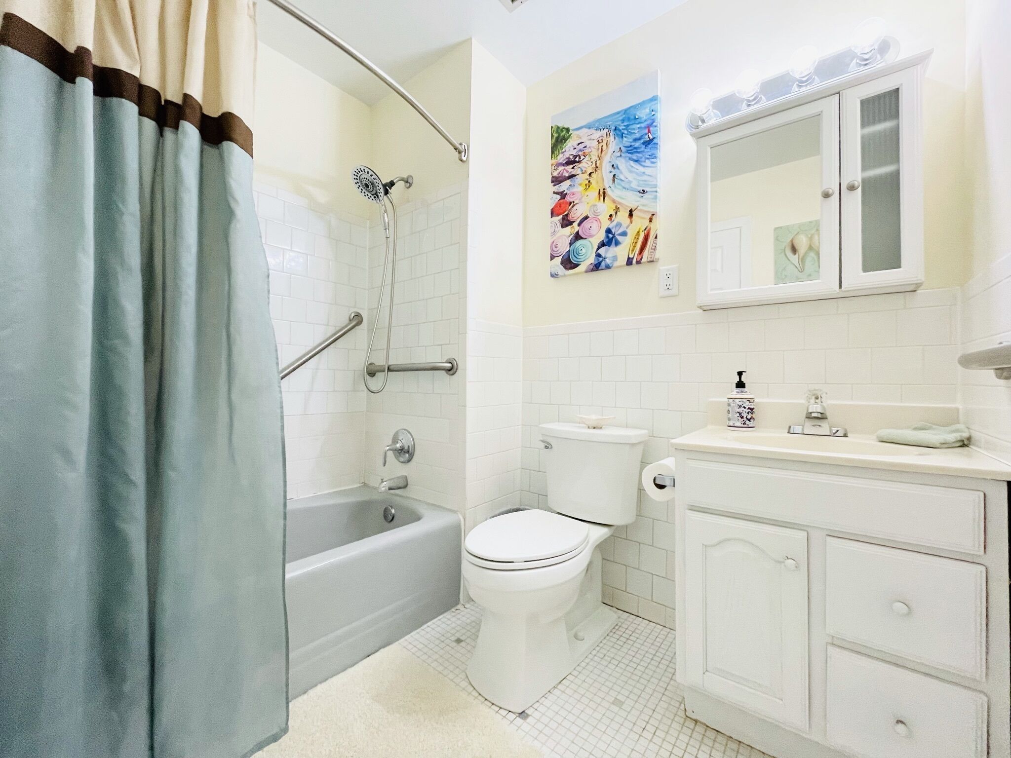 A bathroom with a bathtub, toilet, and sink.