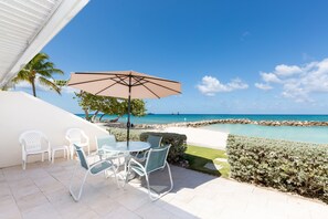 Outdoor dining - Enjoy terrific sunsets from this oceanfront 1st floor, corner unit! (Grand Cayman SC132)