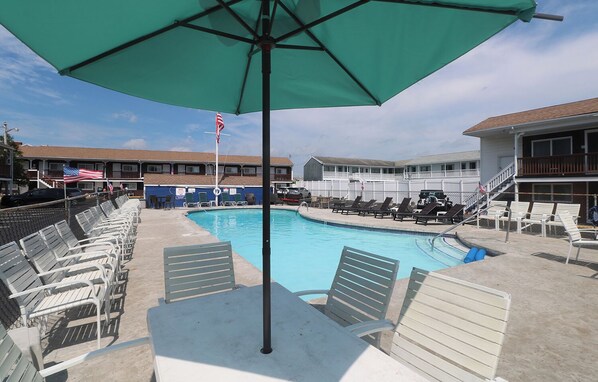 Seasonal outdoor pool, open 9 AM to 9:30 PM, pool umbrellas