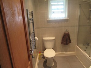 A bathroom with a toilet, a glass shower enclosure, and a towel hanging on the wall. - No 8 (Liverpool)