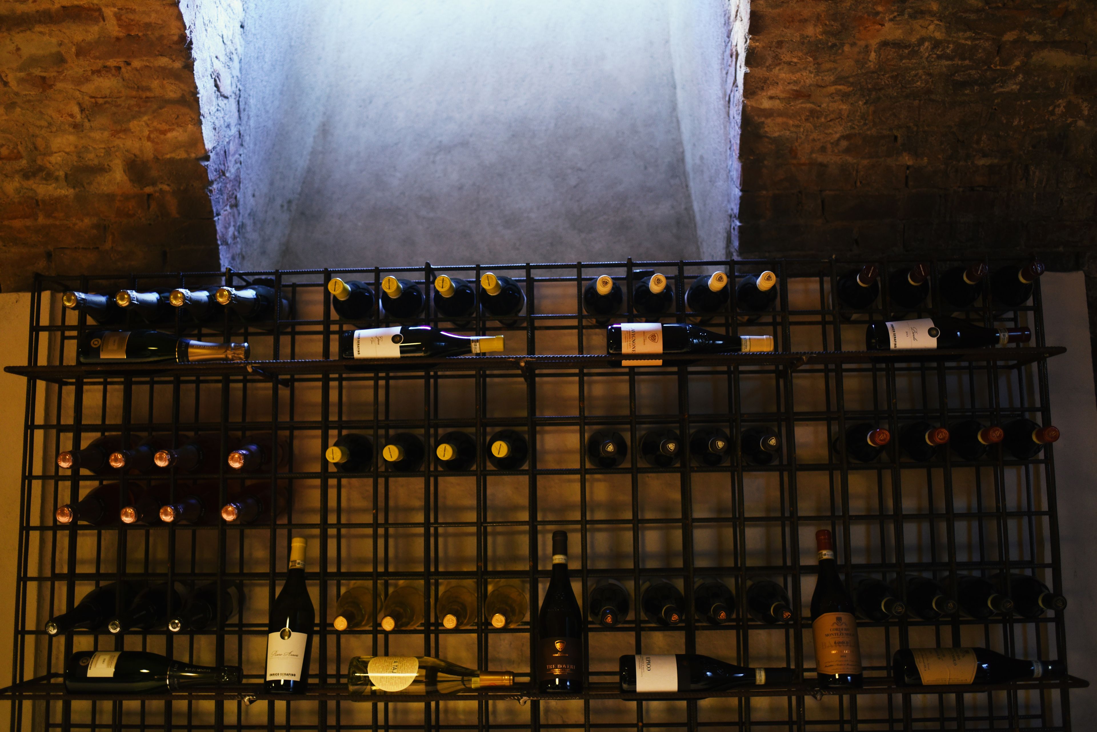 A wine rack with multiple bottles of wine.