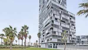 A modern high-rise building with multiple balconies and a flat roof. - Two bedroom apartment with terrace - You Stylish (Barcelona)