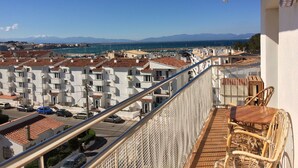 A balcony with a view of a coastal town, featuring terraced buildings and a clear sky. - IMPRESSIVE VIEWS, POOL-GARDEN, CLIMATIZACION, WiFi. NEAR SEA HUTG-02835 (L´escala)