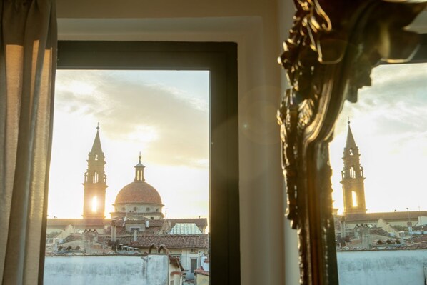 A view through a window of a building with a dome and two towers, possibly a historical or religious structure.