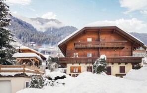 Experience the charm of a traditional chalet with a spacious balcony and stunning mountain views.