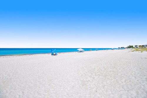 Waterfront condo with pool and easy access to sugar sand beach