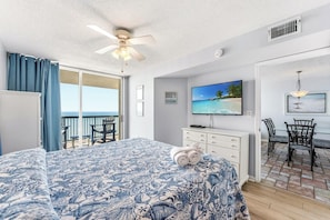 A bedroom with a bed, a TV, a desk, and a chair. - Beachfront Condo, AshWorth, Free Wifi, Pools, Hot Tub | AshWorth - 1806 (North Myrtle Beach)